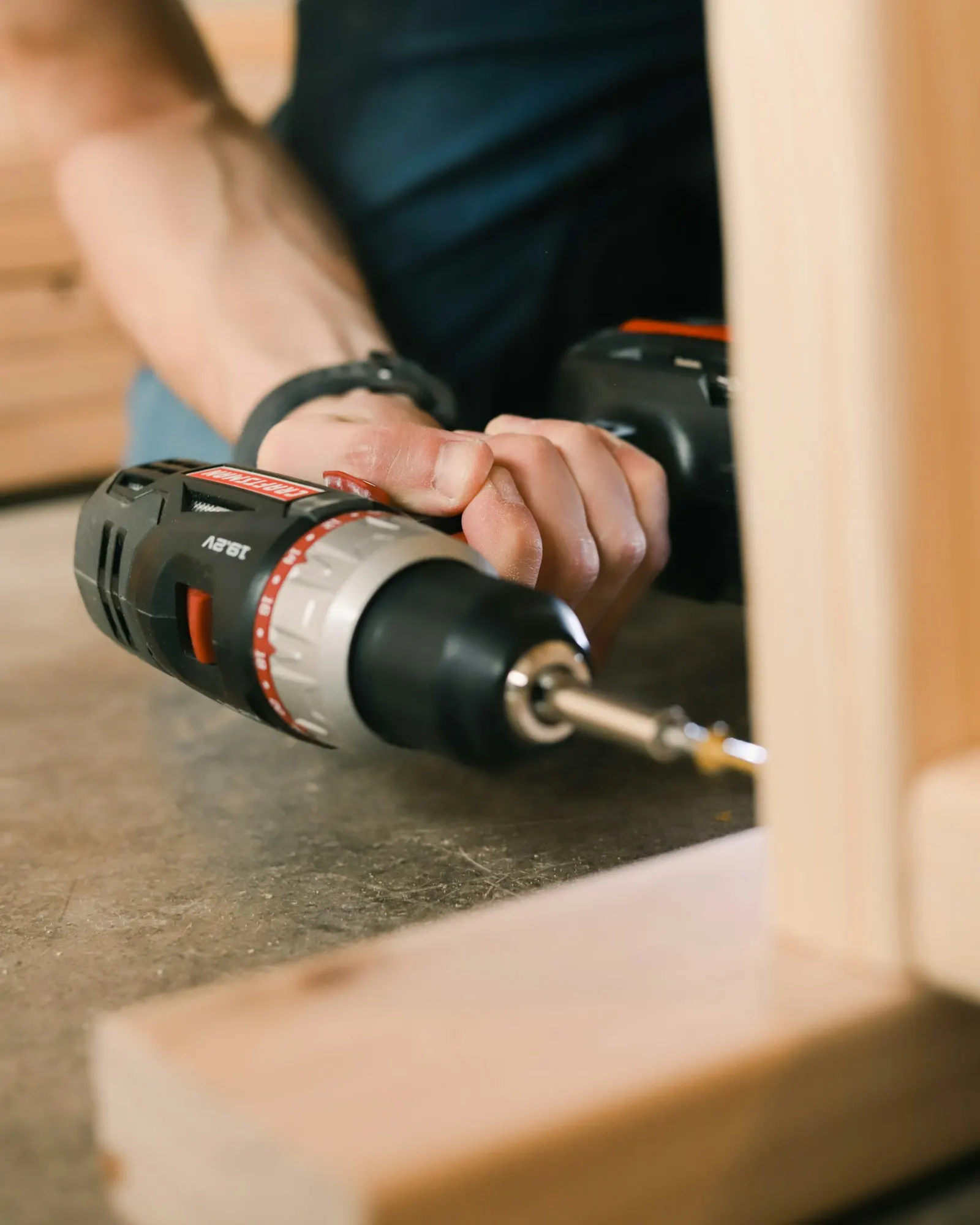 Handyman assembling furniture with a cordless drill